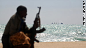 A Somali pirate watches a hijacked ship just off the Somali coast in January.