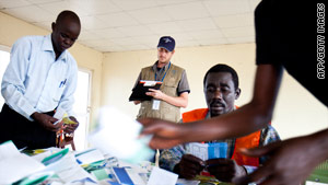 An election observer monitors the counting of ballots at a polling station at a military barracks in southern Sudan.