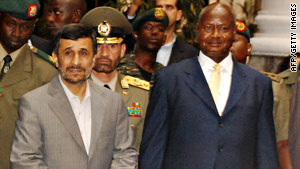 Iranian President Mahmoud Ahmadinejad, left, is welcomed by Uganda's Yoweri Museveni.