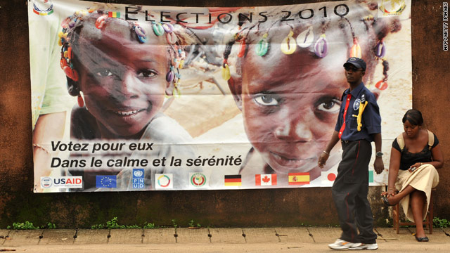 A banner in Conakry, Guinea, on Friday urges people to vote in "calm and serenity" during Sunday's balloting.