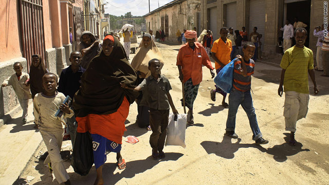 Residents of Mogadishu flee with their belongings from Hamarweyne District of the embattled Somalia capital on July 19, 2010.