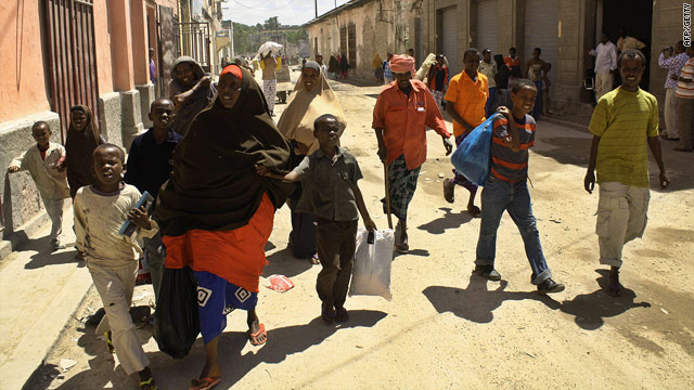 Residents with their belongings in the Somali capital Mogadishu on July 19 after a fresh drive by insurgents.