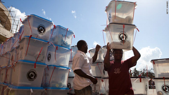 Election officials collect ballot boxes at a tallying center in Dar Es Salaam on November 1.