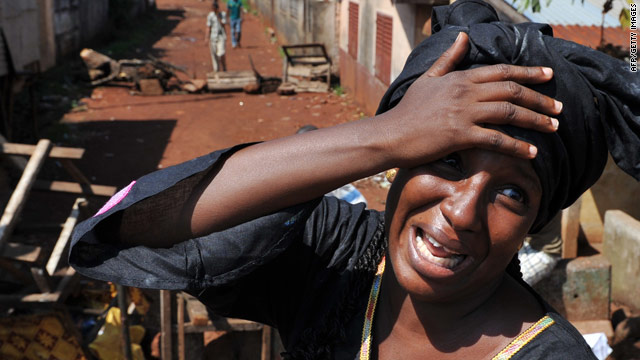 A woman cries on Thursday at the death of a relative killed in the wake of Guinean presidential elections.