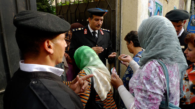 Police check voters' identification at a polling place in Cairo, Egypt, on Sunday.