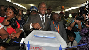 Ivory Coast's former PM and presidential candidate Alassane Ouattara casts his vote on Sunday in Abidjan.