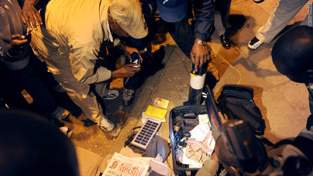 Investigators examine luggage believed to have been abandoned on a street near where the bombing occurred on Monday.