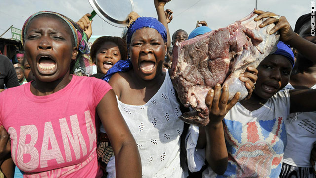 Women holding slabs of meat protest against murders in the Abattoir neighborhood in Abidjan on Wednesday.