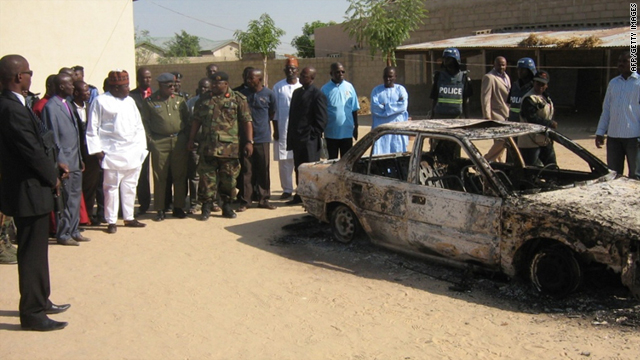 borno state governor ali modu sherif in white kaftan inspect the charred remains of - Christmas Bombings borno state governor ali modu sherif in white kaftan inspect the charred remains of - Christmas Bombings