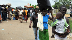 People wait in Abobo, a suburb of Abidjan, on Thursday for transport to visit their families during a general strike.