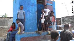 Members of Youth for the Development of Shada clean a toilet built in their community.