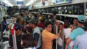People crowd a store in Caracas, Venezuela, on Saturday, after the nation's currency was devalued.
