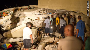 A devastating earthquake leaves much of Haiti's capital in ruins. People search for survivors at a supermarket Tuesday.