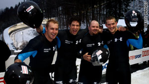 U.S. bobsled pilot Steven Holcomb, second from right, celebrates with teammates after recent bobsled run.