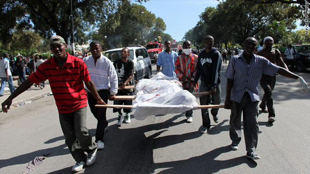 Men carry bodies for burial down a street in Port-au-Prince, Haiti, on Thursday. The earthquake's death toll is unknown.