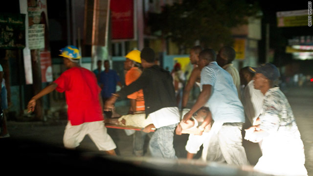 An injured Haitian is carried on a litter shortly after a magnitude 7.0 earthquake struck near Port-au-Prince.