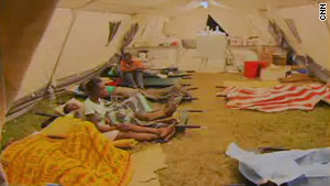 Patients are lined up in a makeshift hospital in a tent in Haiti.