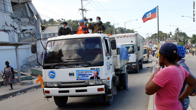 A convoy of trucks carrying relief supplies rolls through the Petionville suburb of Port-au-Prince.