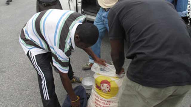 People collect aid in the form of rice at the presidential palace on Monday in Port-au-Prince, Haiti.