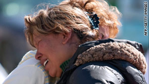 Relatives of youths killed during a party in Juarez mourn on Monday in the neighborhood where the killings happened.