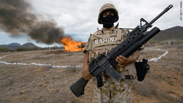 A Mexican marine stands guard as 7,000 kilograms of seized marijuana are incinerated on July 9, 2009, at the naval base in Guaymas, Sonora state, Mexico.