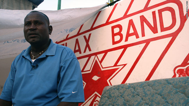 Ernst Beauvais, Relax Band coordinator, sits on a neighborhood stage in Port-au-Prince that now houses a water bladder tank.