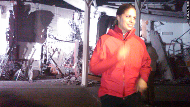 Soledad O'Brien reports in front of a flattened building in Chile. She and her team have left Chile with mixed emotions.