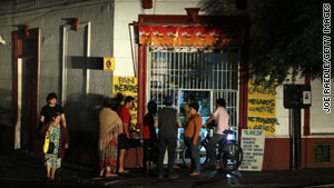 People in Santiago, Chile, gather outside a store after a power outage hit most of the country Sunday.