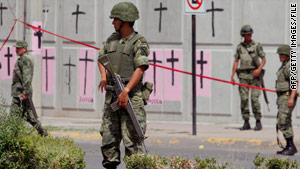 Mexican soldiers secure a site in Ciudad Juarez in September where two federal police officers were killed.