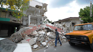 A man walks past the rubble of a health center in Port-au-Prince, Haiti, on Monday.