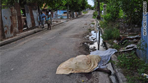 A body lies in the streets in the Trench Town neighborhood of Kingston, Jamaica, this week.
