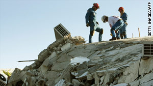 Workers search for survivors, including Rick Santos, who was rescued after 50 hours pinned in the hotel rubble.