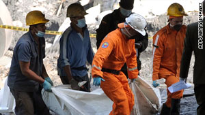 Workers remove a victim's remains from the mine in the municipality of Amaga, Colombia.