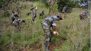 Bolivian soldiers destroy a coca plantation north of La Paz, Bolivia, on March 11.