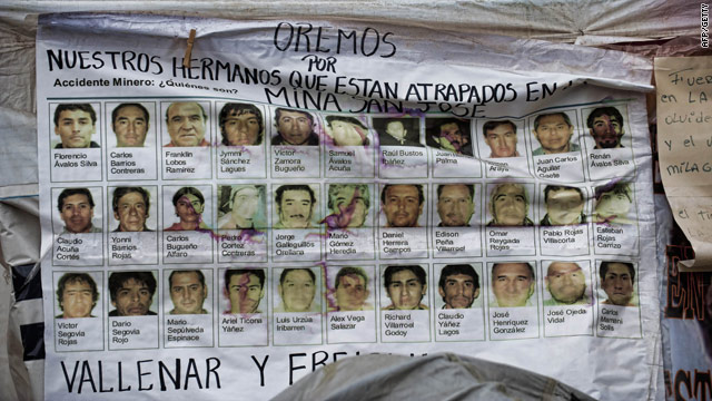 A banner shows pictures of the 33 miners trapped in the San Esteban gold and copper mine in Copiapo, northern Chile.