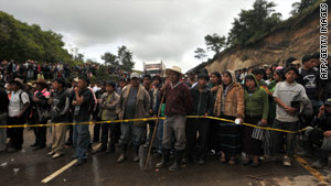 Relatives of missing people wait Sunday in Solola, west of Guatemala City, near the site of a recent landslide.