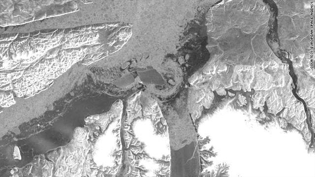 An image from ESA's ENVISAT satellite shows the ice island has split in two while passing through the Nares Strait.