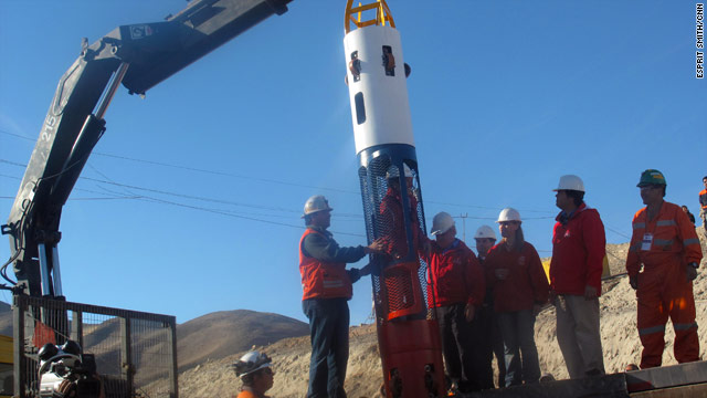 Chilean government and mine officials demonstrate the newly arrived "Phoenix Capsule" at the San Jose mine Saturday.