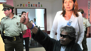 Mario Gomez is escorted through Copiapo Hospital in Copiapo, Chile, on Wednesday.
