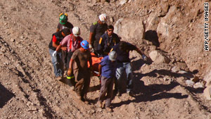 Rescue workers on Monday carry the body a miner who died in the blast at the Los Reyes mine in northern Chile.