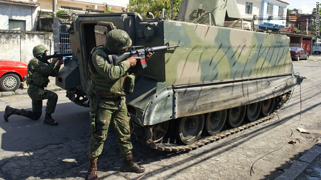 Brazilian soldiers search a man looking for guns at the entrance of the  Mangueira hillside slum in Rio de Janeiro, Brazil, on Wednesday, March 8,  2006. Army troops backed by tanks invaded