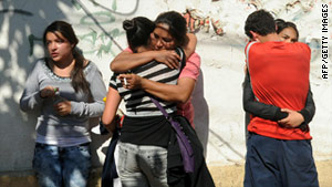 Relatives of inmates wait for news of their loved ones Wednesday outside the San Miguel prison in Santiago, Chile.