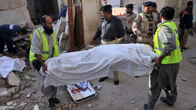 Volunteers remove a body from the rubble of a collapsed house in Karachi, Pakistan, following Friday's explosion.