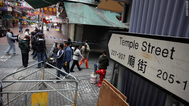 Pedestrians gather on Temple Street which was the scene of an acid attack.