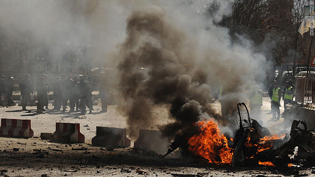 Afghan police watch the flames after a suicide attack blamed on the Taliban in Kabul, Afghanistan, on January 18.