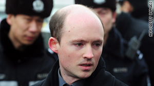 Police watch European Union official Simon Sharpe on Thursday in Beijing discuss the Liu Xiaobo case.