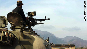 A Pakistani paramilitary soldier sits on a tank Saturday. Pakistan has been launching offensives against the Taliban.