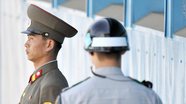 North Korean soldier (L) and a South Korean soldier (R) stand guard at the truce village of Panmunjom in September 30.