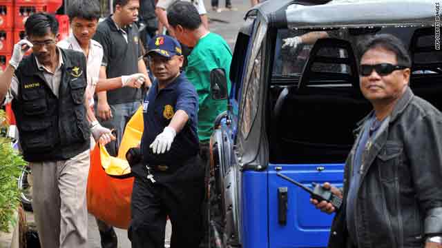 Policemen carry a body during a raid on terror suspects in Pamulang, Indonesia, on Tuesday.