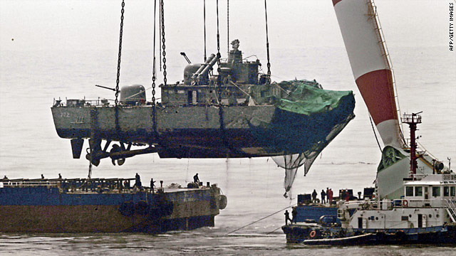A giant floating crane lifts the stern of the South Korean warship onto a barge.